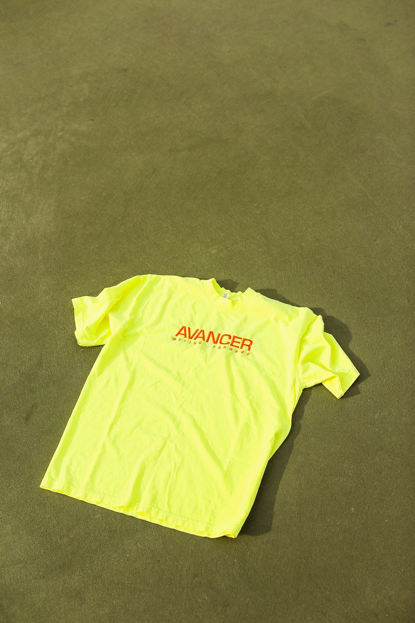 Neon tee on tennis court 